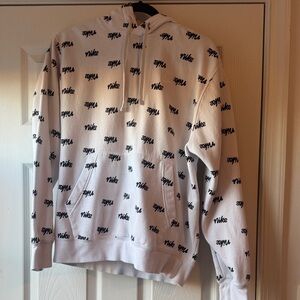 Nike Men's White Zip-Up Sweater with Black Logo Pattern